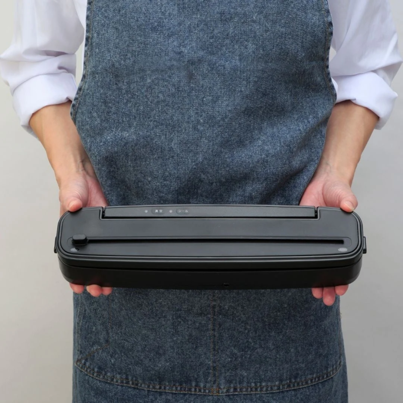 Person holding the vacuum sealer