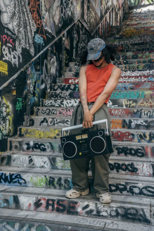 Person with boombox on stairs