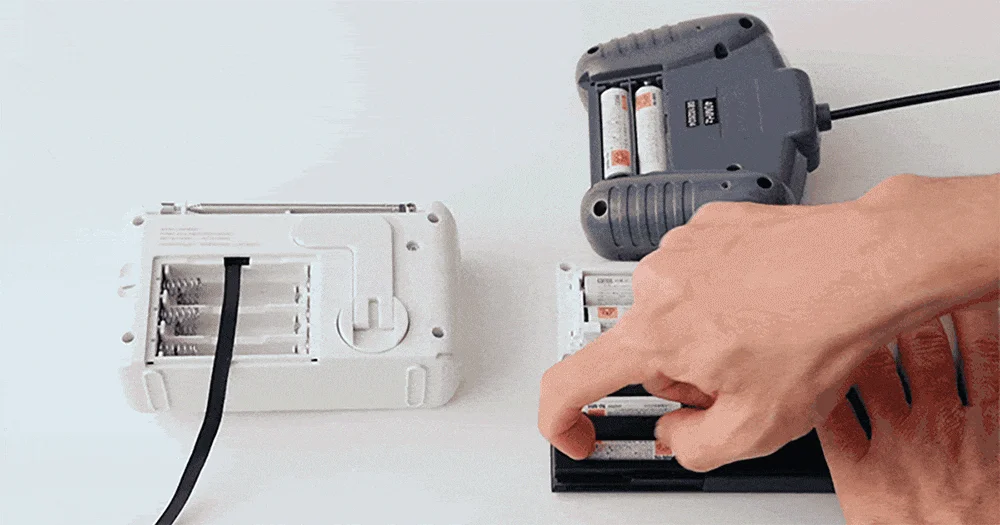 Hand putting battery