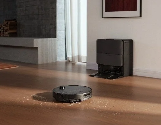 Robot vacuum cleaning a floor with debris