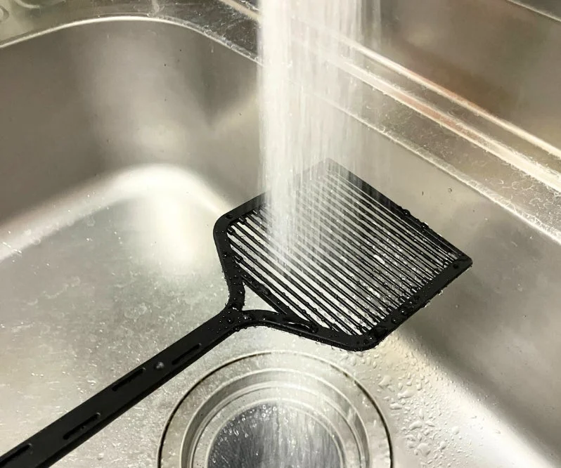 STUN-G being rinsed under water