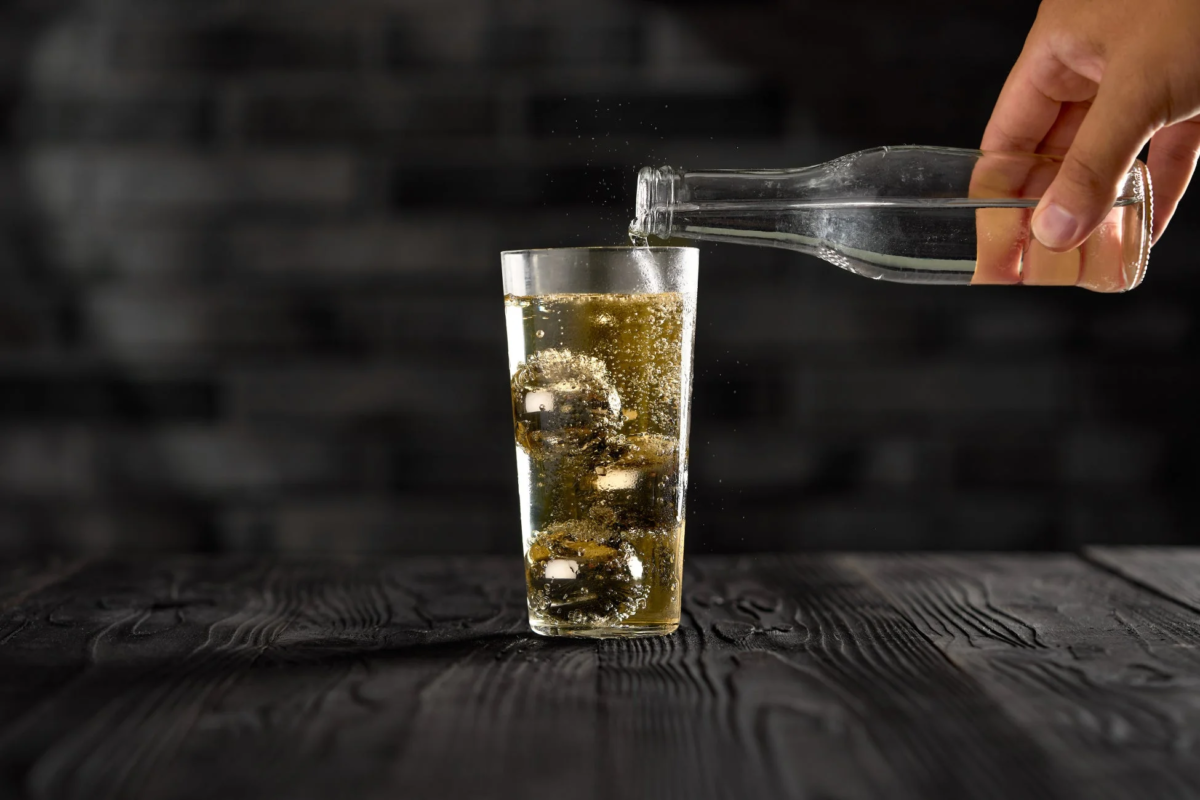 Pouring a drink into a glass with "GRACIA TITAN PLUS"