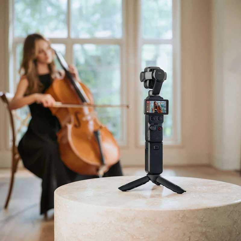 Woman playing cello, camera filming