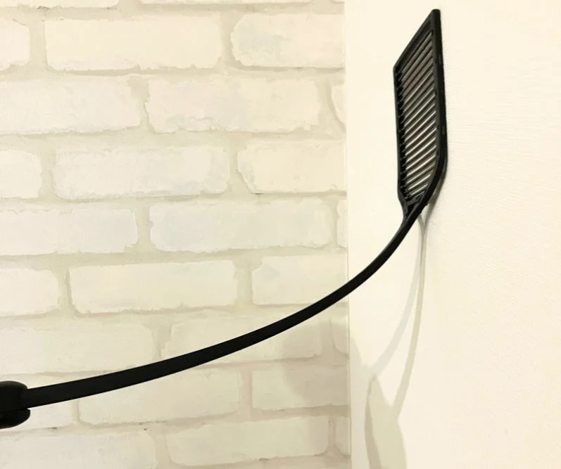STUN-G leaning against a wall