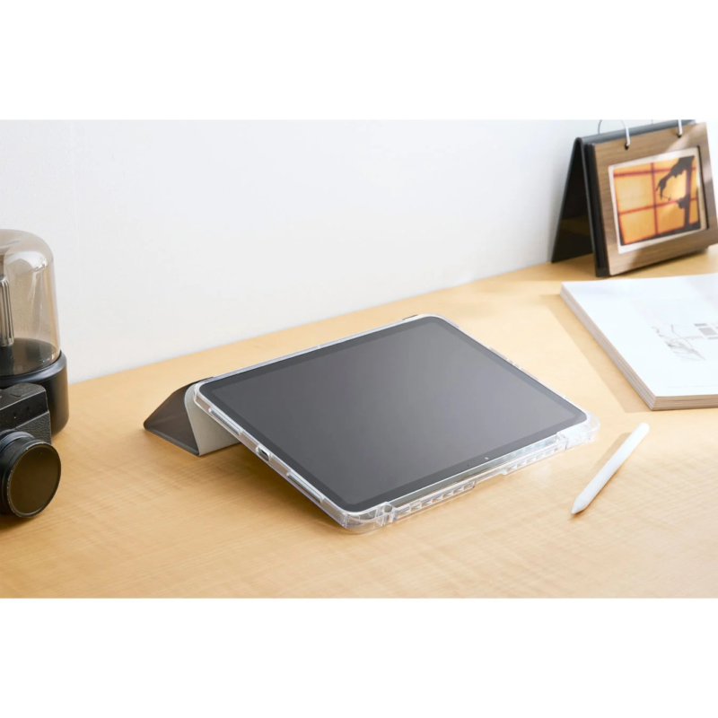 Tablet in a clear case with a stylus on a wooden desk