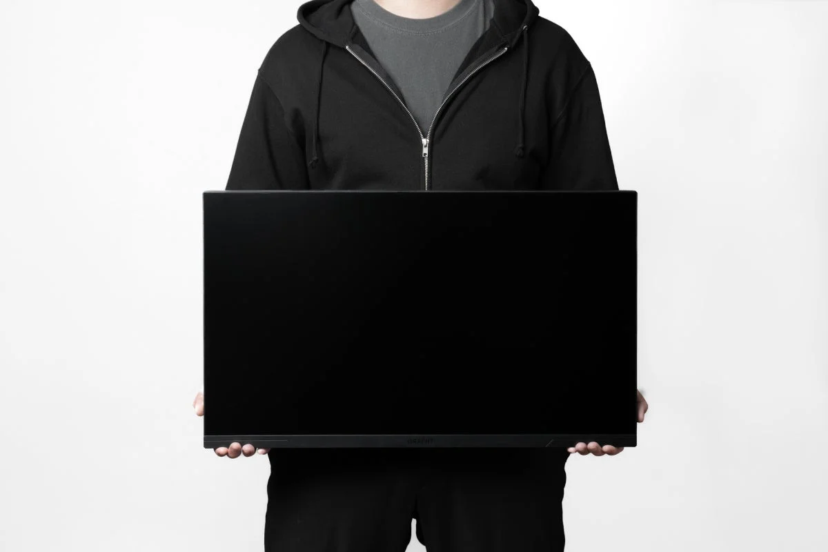 Person Holding Monitor