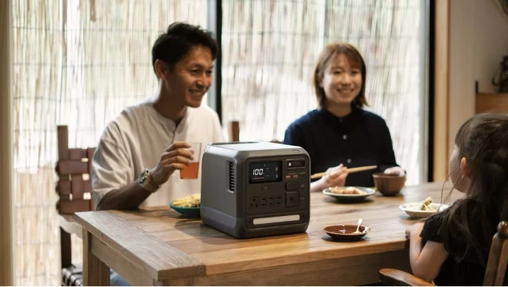 Family with a portable power station at a dining table