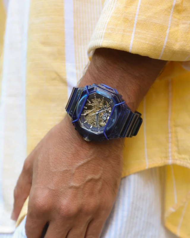 Blue skeleton watch on a wrist