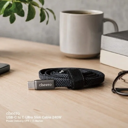 cheero USB-C cable on a wooden desk with a coffee cup and glasses