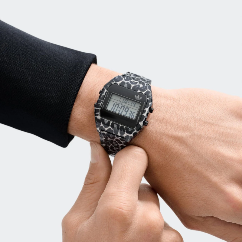 Close-up of a hand wearing a leopard print adidas Digital Two watch