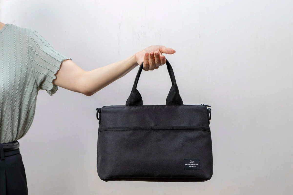 Person holding BATTERY SHIELD BAG
