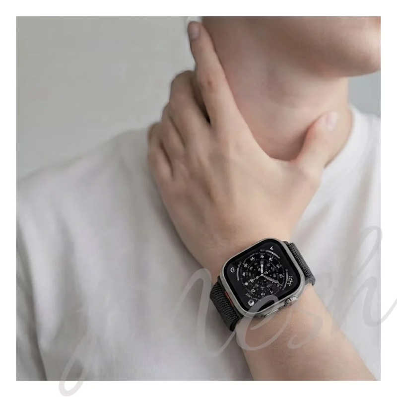 Male wearing black band Apple Watch
