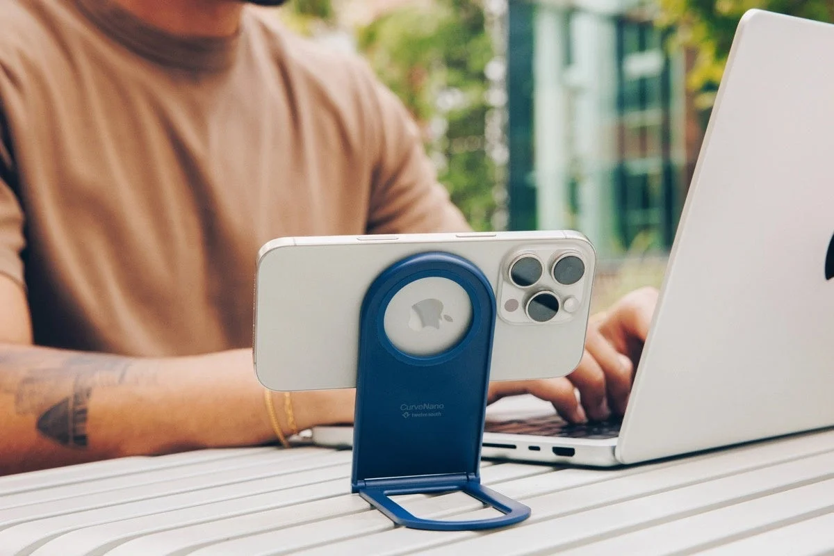 MacBook with iPhone on Twelve South Curve Nano stand