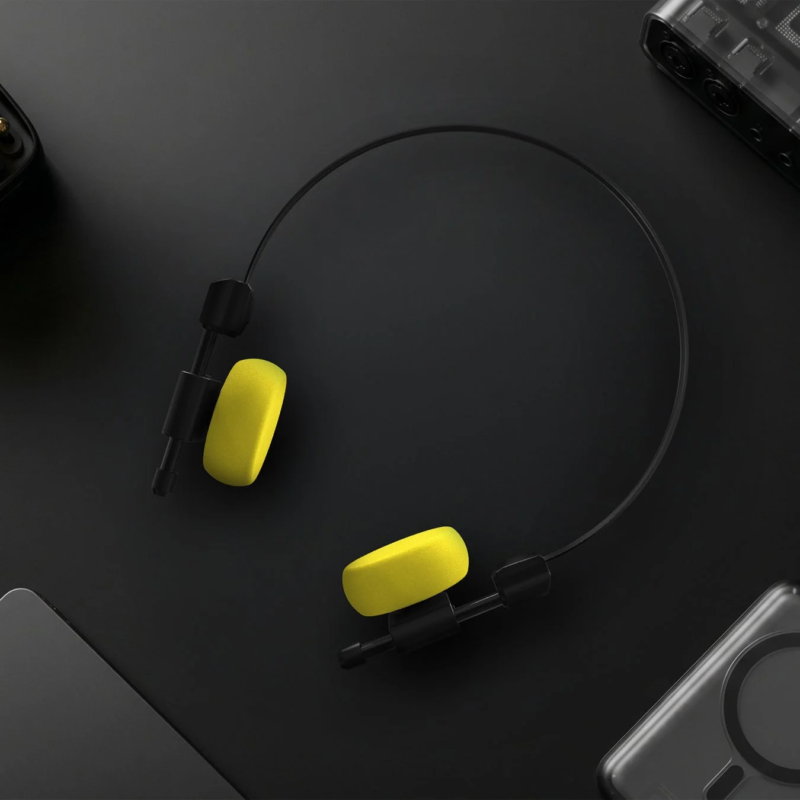 Close-up of black headphones with vibrant yellow ear pads