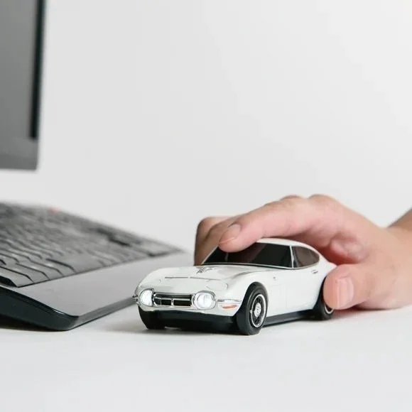 Hand holding Toyota 2000GT Mouse