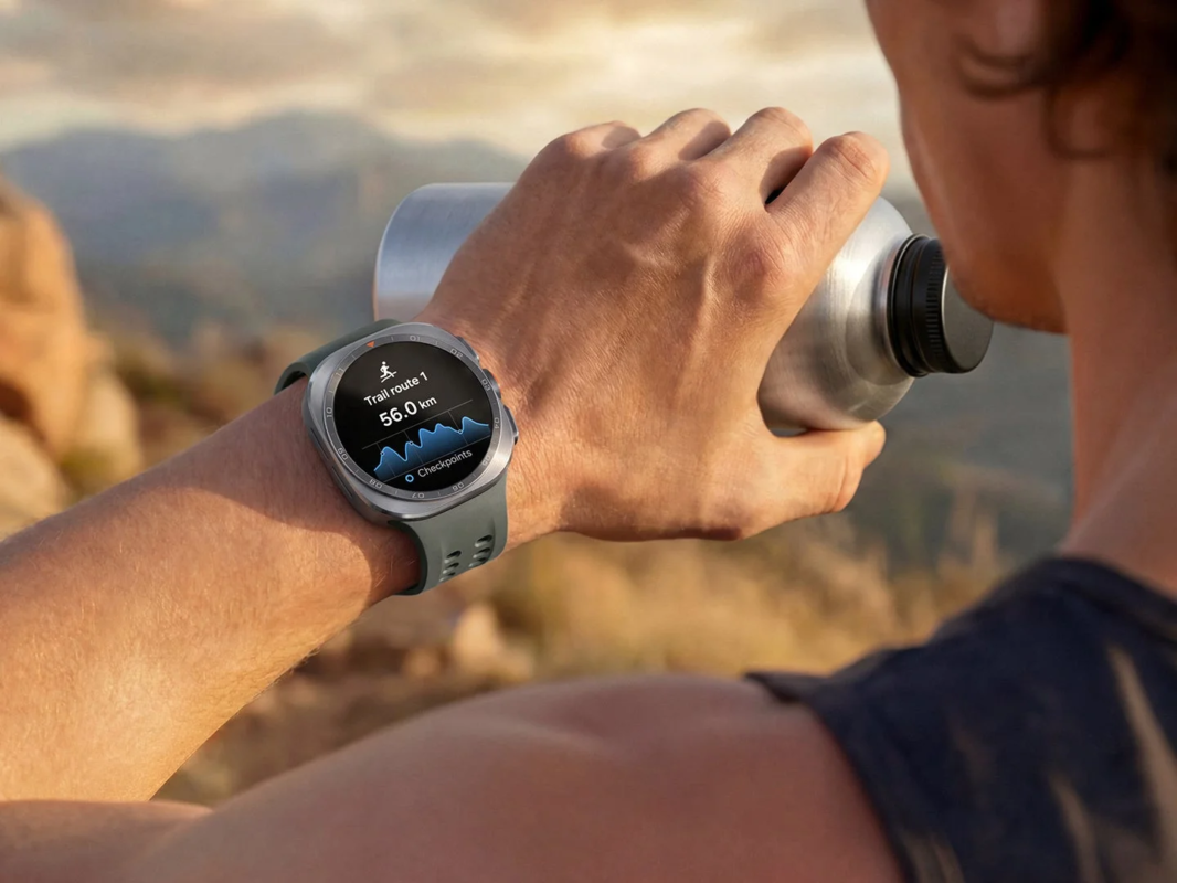 Man hydrating while checking Galaxy Watch Ultra2 on a trail