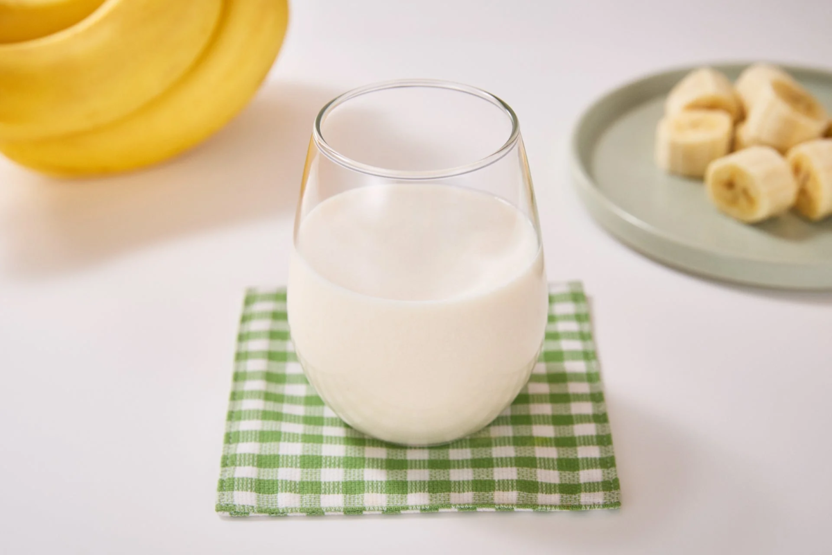 Glass of banana milk with bananas