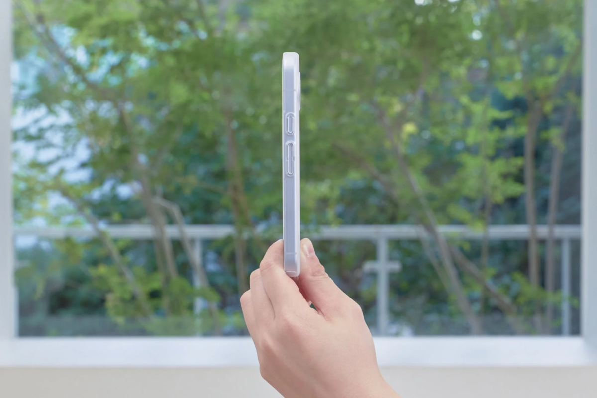Smartphone with clear case, held by hand