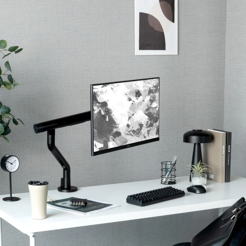 Modern desk with black monitor arm