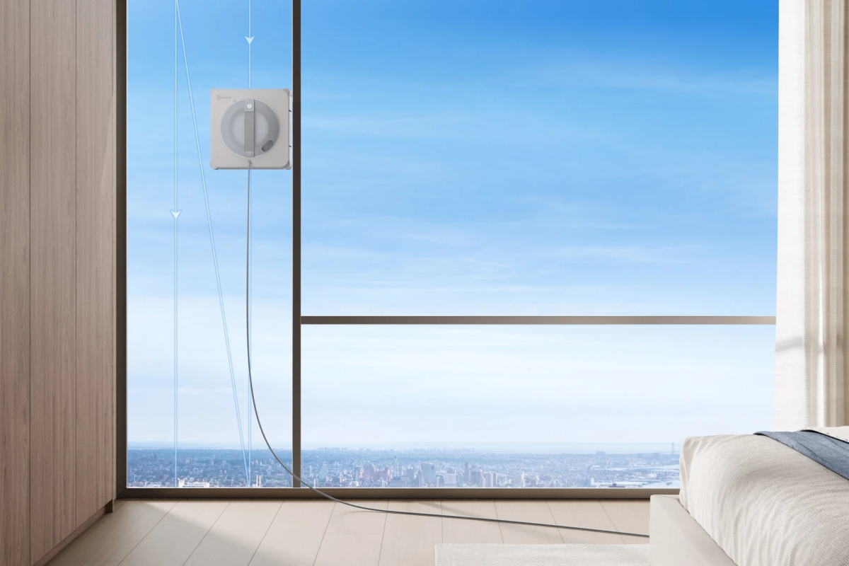 WINBOT cleaning a large window in a high-rise room