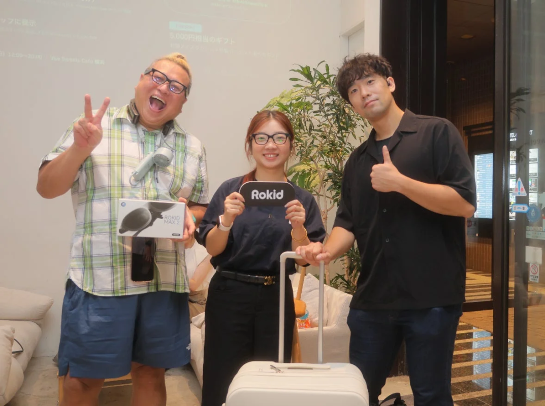 People posing with Rokid products and Aww suitcase