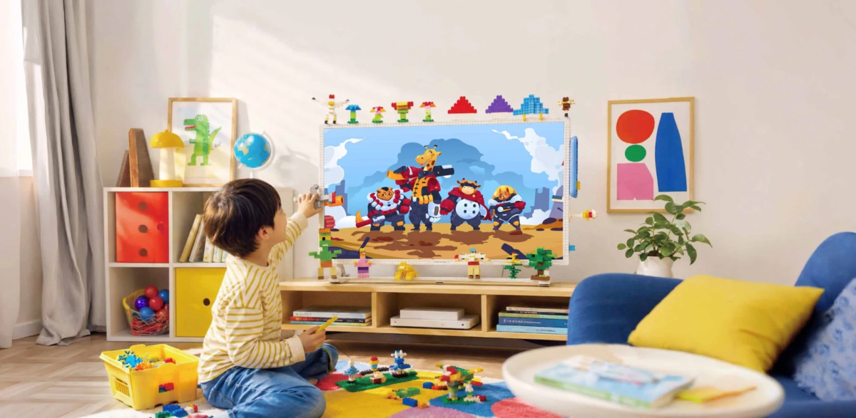 Child playing with blocks near TV