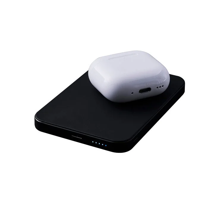 AirPods charging wirelessly on the mobile battery