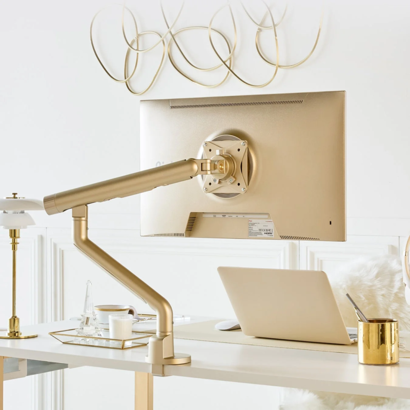 Elegant workspace with gold monitor arm