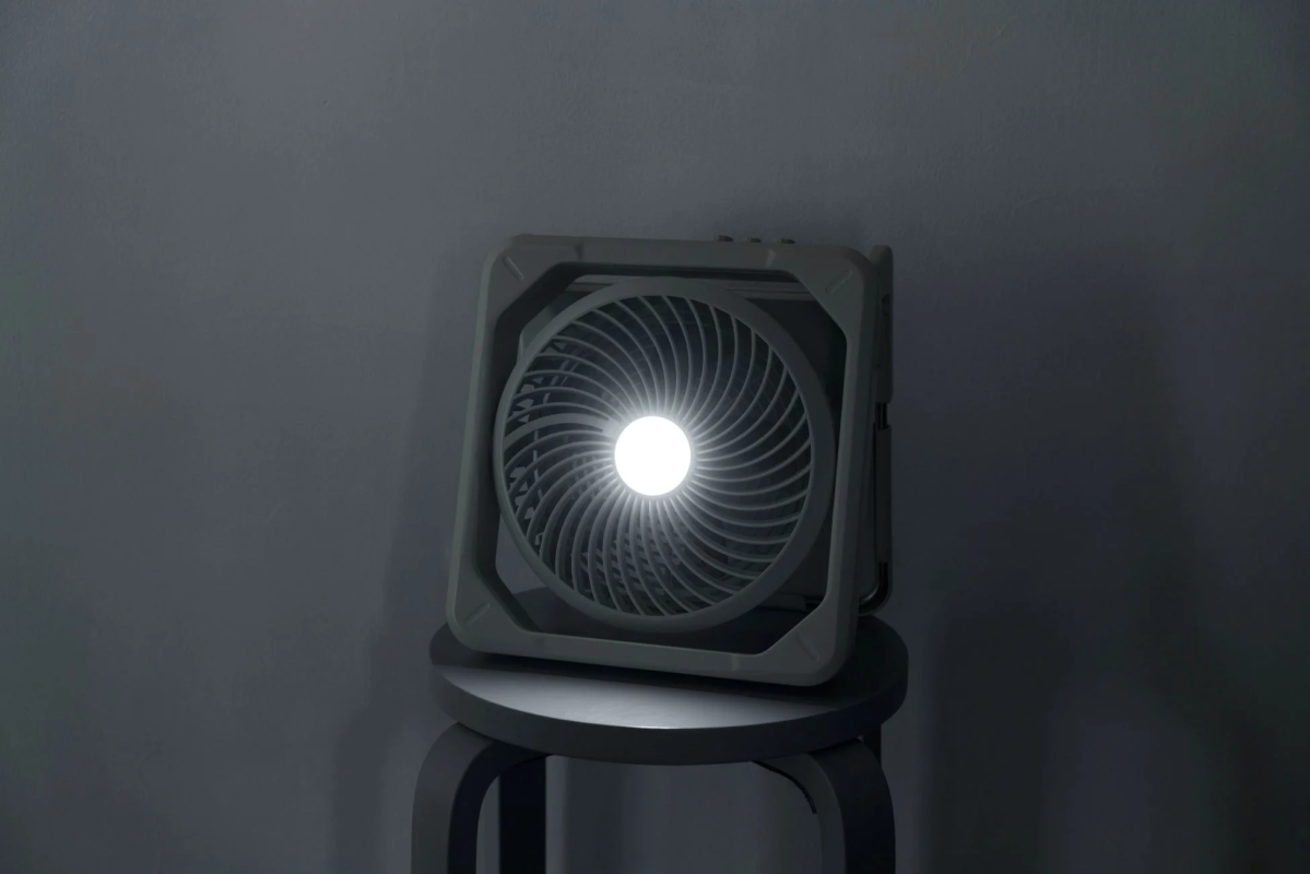Portable fan with LED light in a dark room