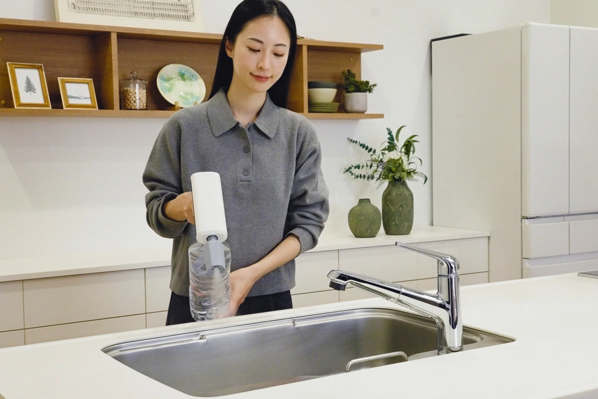 Woman filling a portable device from a bottle