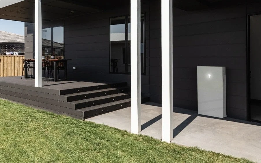 Modern residential exterior with a Tesla Powerwall battery