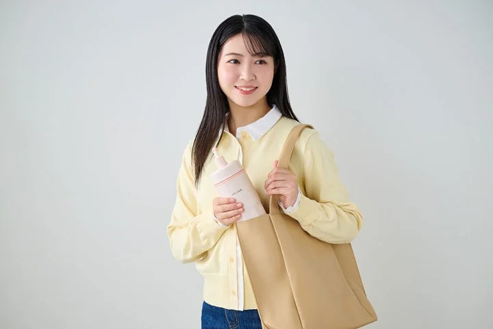Woman putting bottle in bag