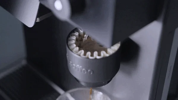 Coffee dripping into a cup