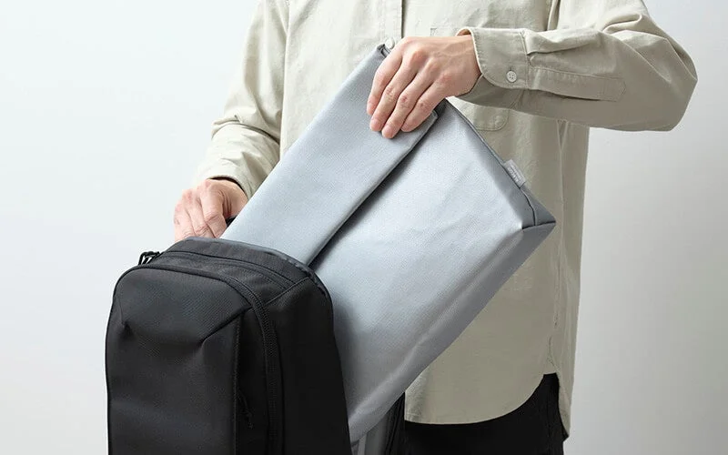 Case being placed into a backpack