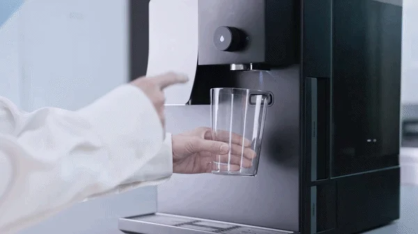 Person holding a glass under the dispenser