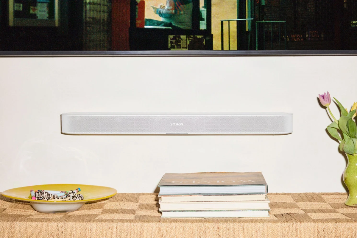 A Sonos soundbar in a modern living space with books and flowers