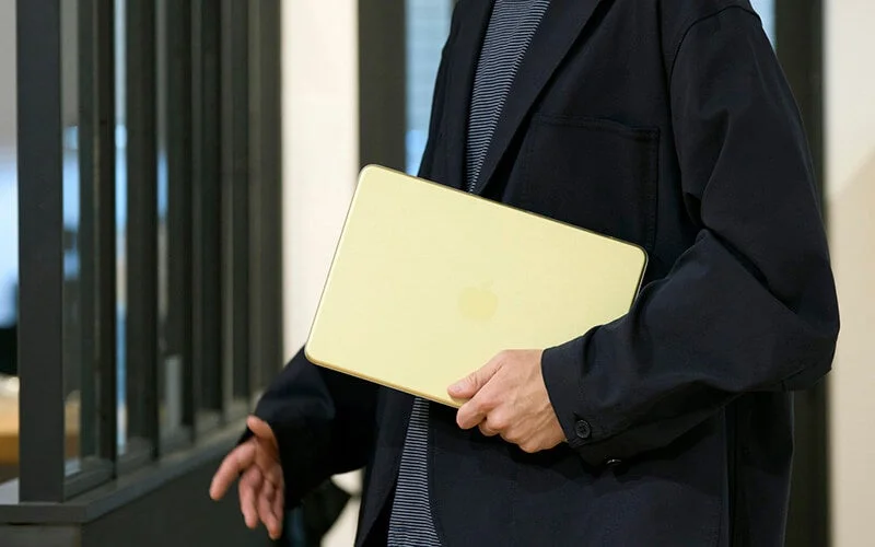 Person walking with MacBook