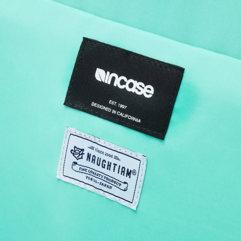 Close-up of Incase and NAUGHTIAM brand tags