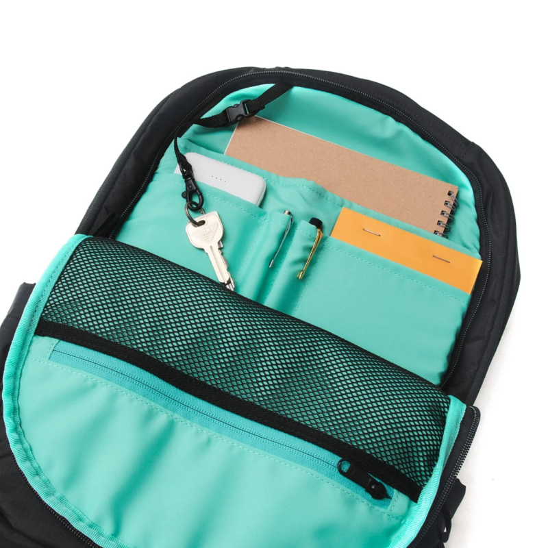 Interior of backpack with mint lining and organized items